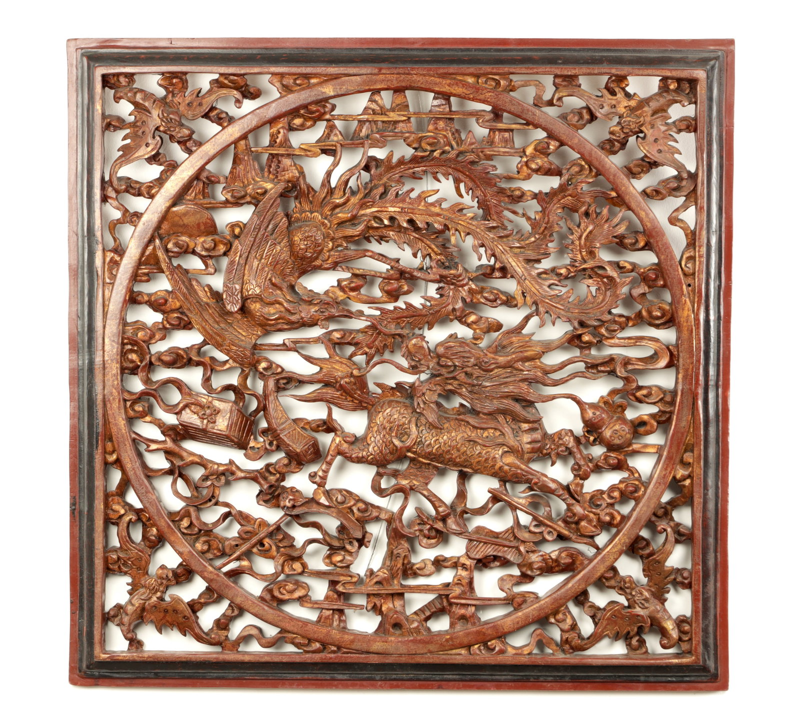 A CHINESE CARVED PAINTED HANGING PANEL WITH GILT HIGHLIGHTS: A CHINESE CARVED PAINTED HANGING PANEL WITH GILT HIGHLIGHTS having pierced decoration of dragons and birds (79cm square )