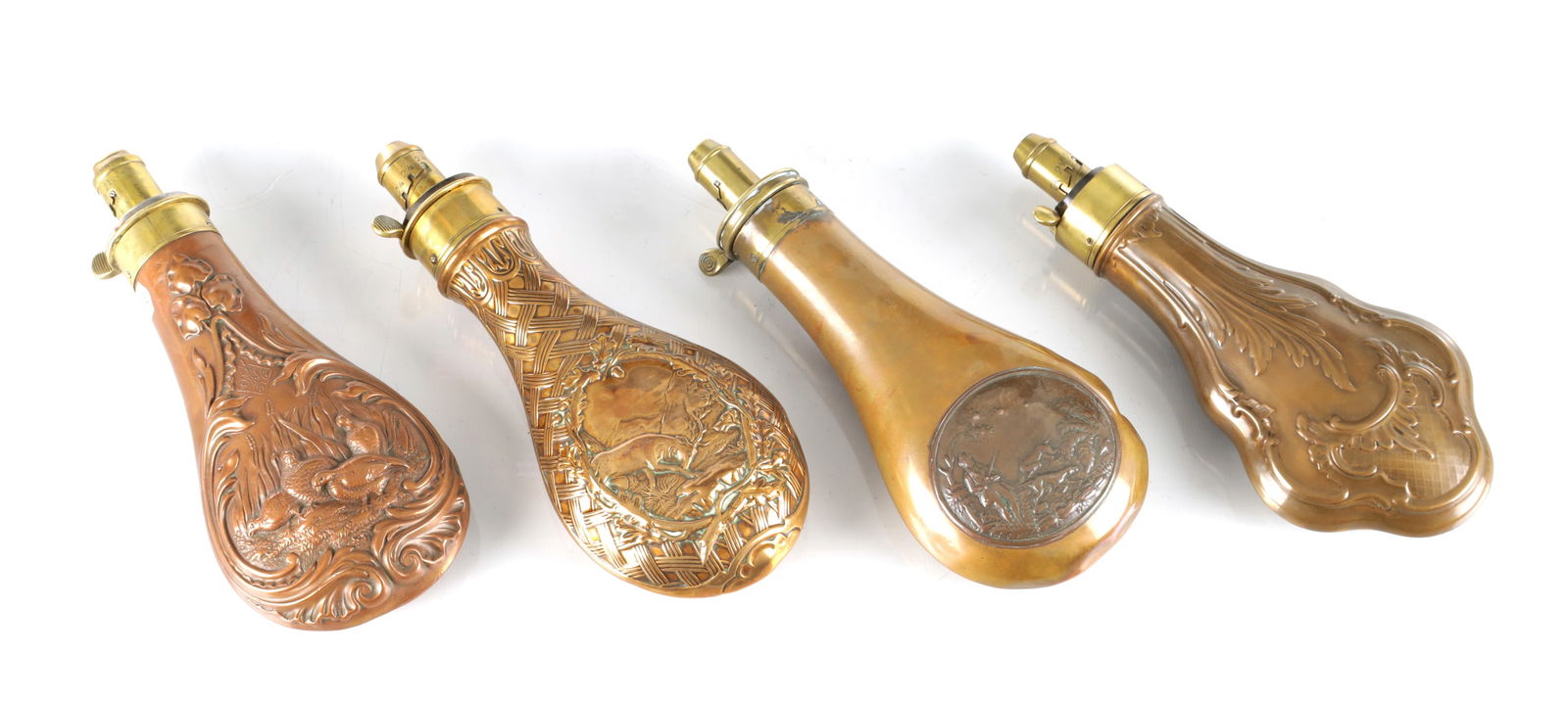 TWO 19TH CENTURY COPPER AND BRASS POWDER FLASKS: TWO 19TH CENTURY COPPER AND BRASS POWDER FLASKS one signed G. & J.W. Hawksley, Sheffield with embossed stag surrounded by a garland of holly within simulated woven work, the other signed by the same m