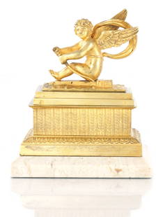 A LATE 19TH CENTURY GRAND TOUR GILT BRONZE AND MARBLE GRAND TOUR INKWELL: A LATE 19TH CENTURY GRAND TOUR GILT BRONZE AND MARBLE GRAND TOUR INKWELL modelled with a winged cherub to the lift-off lid, revealing three compartments on a rectangular engraved stand with acanthus l