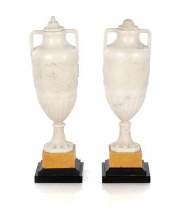 A PAIR 19TH CENTURY ITALIAN GRAND TOUR CARVED CARRARA MARBLE URNS: A PAIR 19TH CENTURY ITALIAN GRAND TOUR CARVED CARRARA MARBLE URNS of neo-classical design with leaf work finials and raised on sienna marble square bases (32cm high )
