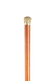 A 19TH CENTURY GILT METAL AND MALACCA WALKING CANE: A 19TH CENTURY GILT METAL AND MALACCA WALKING CANE the handle embossed with scroll and foliate designs and engraved monogram M.L.J on a malacca shaft with metal ferrule. (86cm long)
