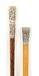 TWO A 19TH CENTURY INDIAN WALKING STICKS: TWO A 19TH CENTURY INDIAN WALKING STICKS one with tapering brass coppered handle engraved with deity on a zebrawood shaft, the other of similar design with silver metal handle on a malacca shaft (96cm