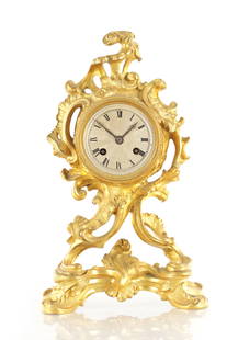 A 19TH CENTURY FRENCH ORMOLU ROCOCO MANTEL CLOCK: A 19TH CENTURY FRENCH ORMOLU ROCOCO MANTEL CLOCK the silvered 3" dial with Roman numerals fronting a spring-driven French eight-day striking movement with silk suspension and anchor escapement strikin