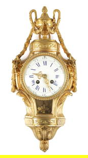 A SMALL 19TH CENTURY FRENCH ORMOLU CARTEL CLOCK: A SMALL 19TH CENTURY FRENCH ORMOLU CARTEL CLOCK surmounted by an urn finial above mistletoe garland and acanthus leaf mouldings, rams head masks and pendulum aperture, the porcelain dial with Roman nu