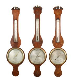 A SELECTION OF THREE GEORGE III SHERATON MAHOGANY WHEEL BAROMETERS: A SELECTION OF THREE GEORGE III SHERATON MAHOGANY WHEEL BAROMETERS two with shell inlays all having silvered calibrated circular dials. (98cm high and smaller)