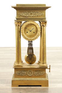 A LARGE EARLY 19TH CENTURY FRENCH ORMOLU PORTICO CLOCK: A LARGE EARLY 19TH CENTURY FRENCH ORMOLU PORTICO CLOCK the gilded case with acanthus leaf moulds and reeded Corinthian columns supporting a 5" dial with Roman chapter ring enclosing an engine-turned c