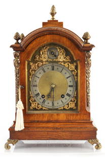 A LATE 19TH CENTURY GERMAN OAK CASED QUARTER CHIMING BRACKET CLOCK: A LATE 19TH CENTURY GERMAN OAK CASED QUARTER CHIMING BRACKET CLOCK, the arched case with ormolu caryatid canted corners enclosing a brass dial with gilt spandrels and silvered chapter ring