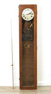 SYNCHRONOME MASTER CLOCK: AN EARLY 20TH CENTURY OAK CASED SYNCHRONOME ELECTRIC MASTER CLOCK the glazed front door enclosing a 6.5" silvered dial with Roman numerals fronting an electric magnetic movement with steel rod pendulu