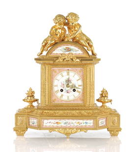 A LATE 19TH CENTURY FRENCH PORCELAIN PANELLED ORMOLU MATEL CLOCK: A LATE 19TH CENTURY FRENCH PORCELAIN PANELLED ORMOLU MATEL CLOCK, surmounted by two cherubs the case inset with six pink and white floral porcelain panels and matching dial with gilt Roman numerals