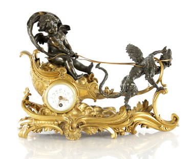 A FINE LATE 19TH CENTURY FRENCH BRONZE AND ORMOLU MANTEL CLOCK IN THE MANNER OF FRANCOIS LINKE: A FINE LATE 19TH CENTURY FRENCH BRONZE AND ORMOLU MANTEL CLOCK IN THE MANNER OF FRANCOIS LINKE the case formed as a chariot been pulled by a dragon and seated winged cherub, enclosing a convex enamel