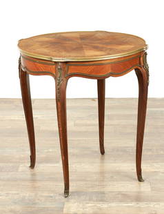 A 19TH CENTURY LOUIS XVI STYLE FRENCH KINGWOOD AND ORMOLU MOUNTED LAMP TABLE: A 19TH CENTURY LOUIS XVI STYLE FRENCH KINGWOOD AND ORMOLU MOUNTED LAMP TABLE with a segmented top above a shaped base and slender cabriole legs (67cm diameter 73cm high )