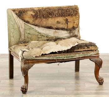 A REGENCY ROSEWOOD COUNTRY HOUSE UPHOLSTERED HALL SEAT: A REGENCY ROSEWOOD COUNTRY HOUSE UPHOLSTERED HALL SEAT with fan carved cabriole legs and paw feet (92cm wide 82cm high)