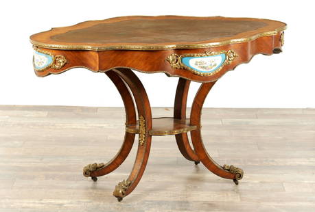 A GOOD 19TH CENTURY KINGWOOD AND ORMOLU MOUNTED PORCELAIN PANELLED SHAPED WRITING TABLE BEARING: A GOOD 19TH CENTURY KINGWOOD AND ORMOLU MOUNTED PORCELAIN PANELLED SHAPED WRITING TABLE BEARING RETAILERS STAMP FOR S & H JEWELL 29,30,31 LITTLE QUEEN HOLBORN the tooled leather top above a shaped apr