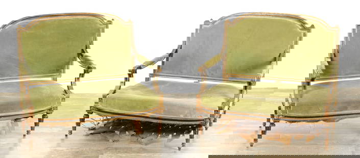 A PAIR OF 19TH CENTURY FRENCH GILT GESSO AND EBONISED TWO SEATER SETTEES: A PAIR OF 19TH CENTURY FRENCH GILT GESSO AND EBONISED TWO SEATER SETTEES with arched upholstered backs having scrolled leaf carved arms and raised on reeded tapering legs (120cm wide 103cm high )