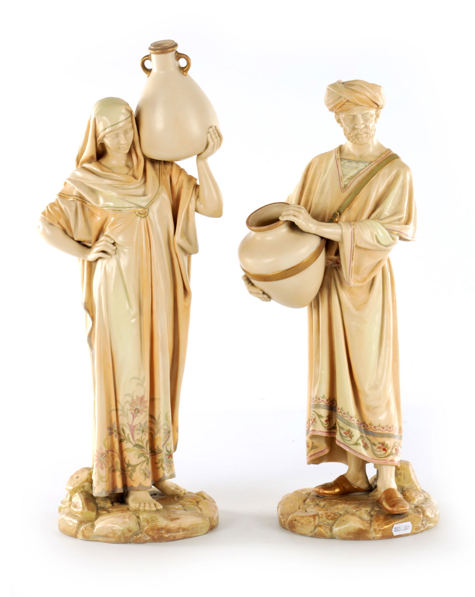 A PAIR OF LATE 19TH CENTURY ROYAL WORCESTER PORCELAIN FIGURES OF WATER CARRIERS: A PAIR OF LATE 19TH CENTURY ROYAL WORCESTER PORCELAIN FIGURES OF WATER CARRIERS modelled as a standing maiden balancing a large amphora on her shoulder and a turbaned man holding a wide-necked jar, ea