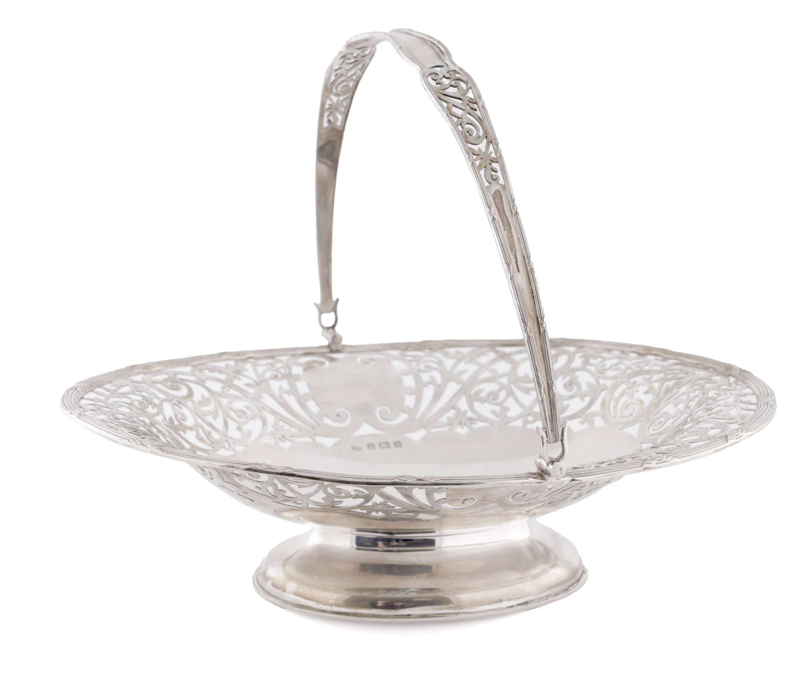 AN EDWARD VII SILVER SWING HANDLED FOOTED BASKET: AN EDWARD VII SILVER SWING HANDLED FOOTED BASKET with pierced scrolled decoration on a moulded foot, Birmingham, 1909, by William Adams Ltd, approximately 646g total. (31cm across)