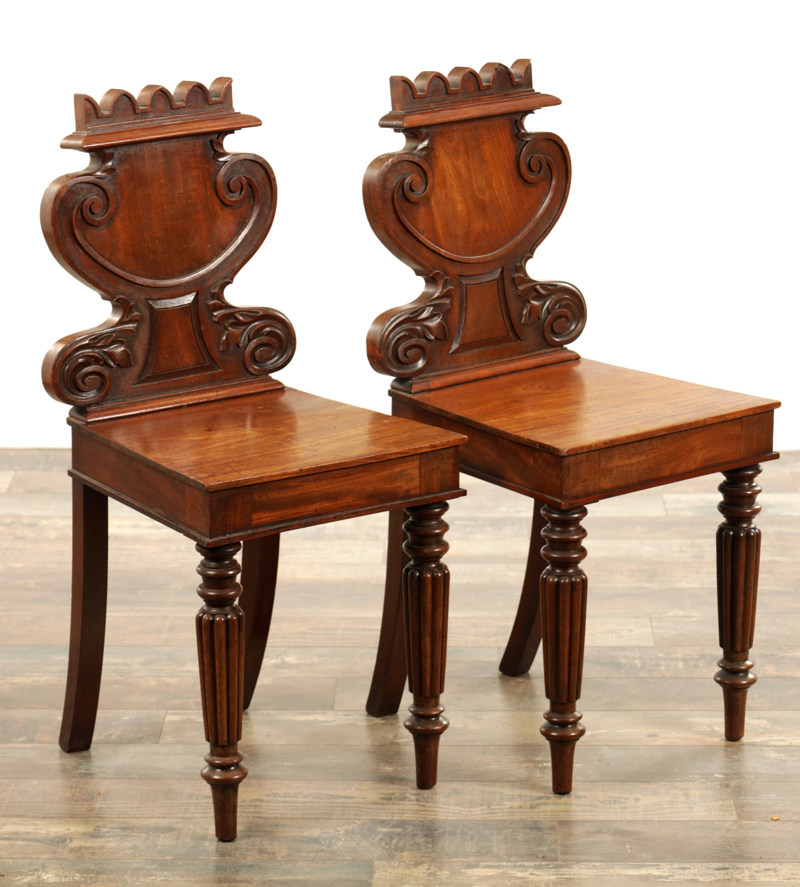 AN UNUSUAL PAIR OF REGENCY FIGURED MAHOGONY HALL CHAIRS IN THE MANNER OF GILLOWS (1 of 6)