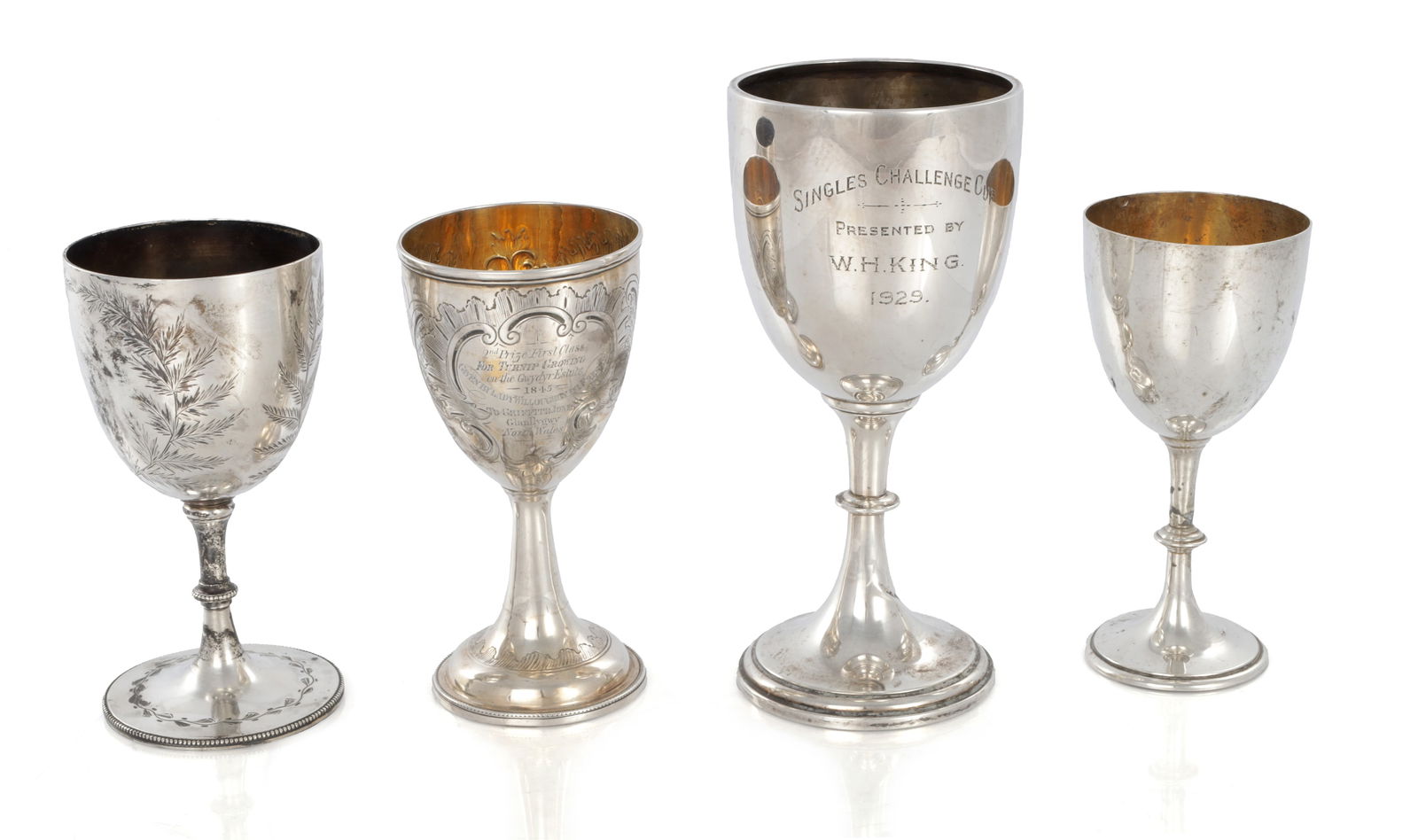 A COLLECTION OF FOUR 19TH/20TH CENTURY SILVER GOBLETS: A COLLECTION OF FOUR 19TH/20TH CENTURY SILVER GOBLETS bearing presentation inscriptions and gilt interiors. Total weight app. 750g. (22cm high and smaller)