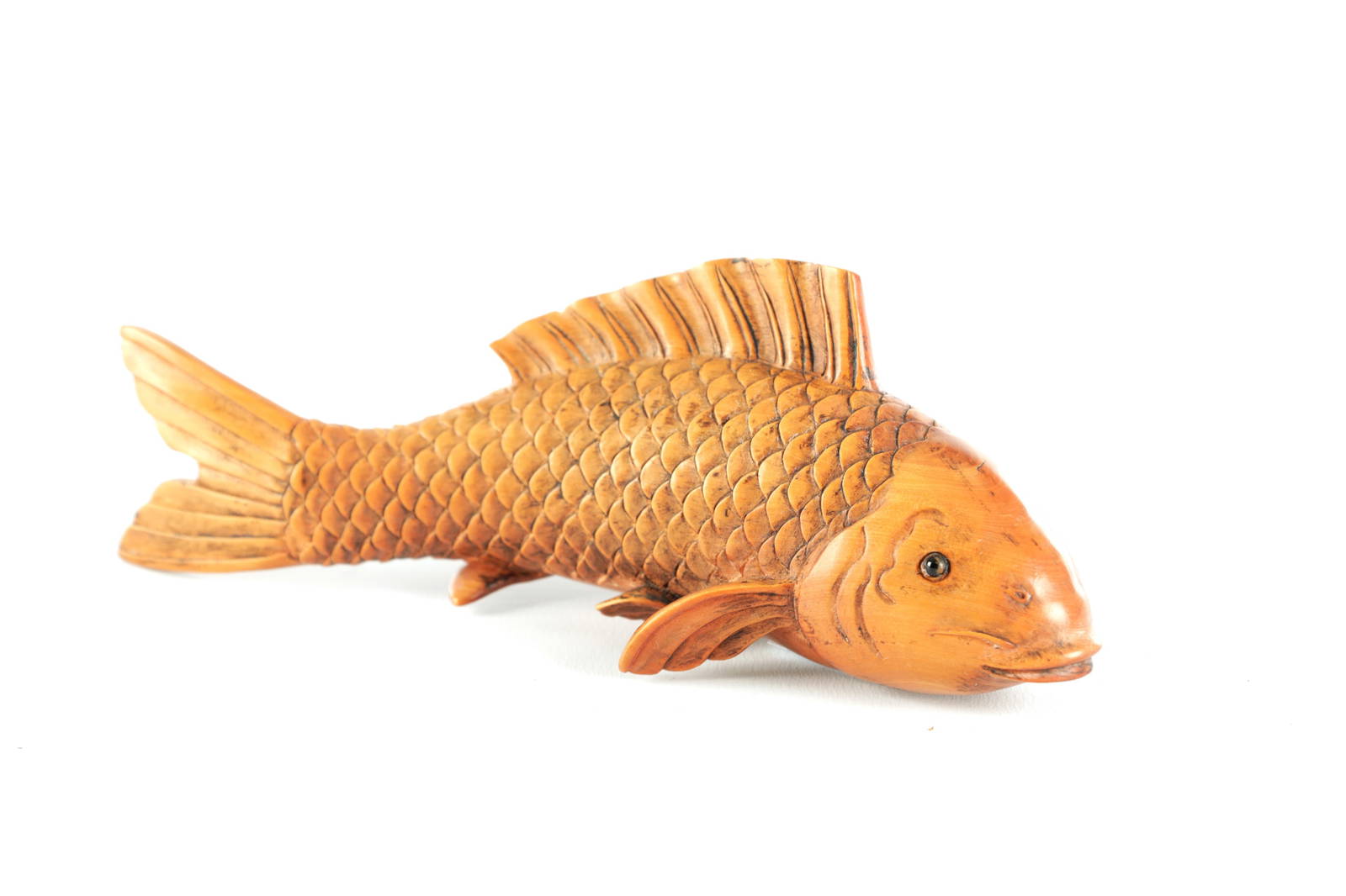 A JAPANESE MEIJI PERIOD CARVED BOX WOOD SCULPTURE OF A CARP