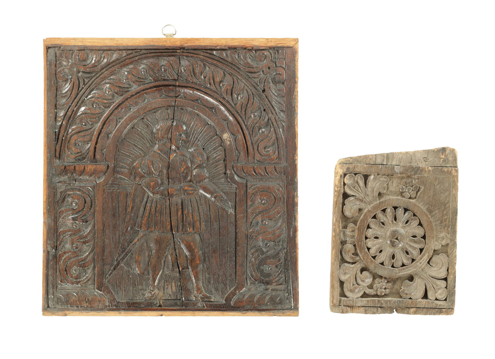 TWO 17TH CENTURY CARVED OAK PANELS: TWO 17TH CENTURY CARVED OAK PANELS the larger panel features a figural carving of a man in Renaissance-style attire, surrounded by a carved arch; the smaller panel features a central floral medallion
