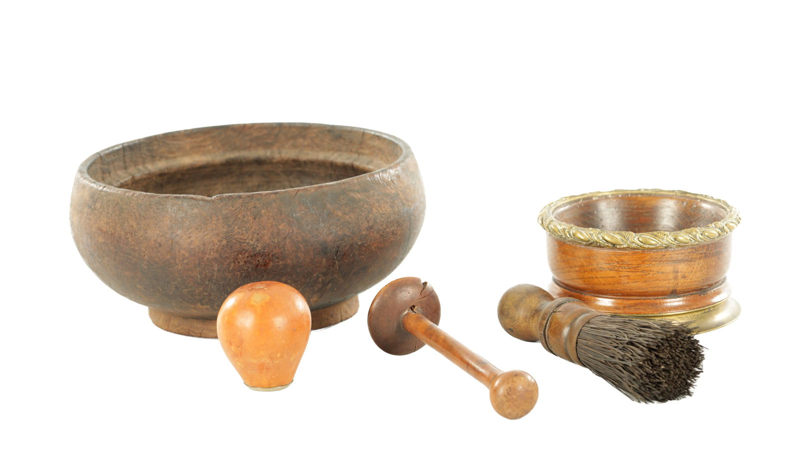 A COLLECTION OF 17TH / 18TH CENTURY WOODEN ITEMS: A COLLECTION OF 17TH / 18TH CENTURY WOODEN ITEMS comprising of an 18th century burr elm treen bowl, together with an early 19th century Georgian brass mounted bottle coaster, a pair of treen pestles a