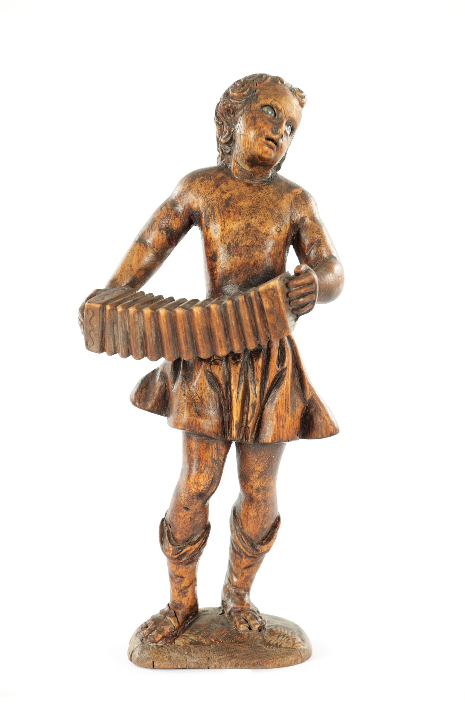 A LATE 18TH/EARLY 19TH CENTURY CARVED WALNUT CONTINENTAL FIGURE: A LATE 18TH/EARLY 19TH CENTURY CARVED WALNUT CONTINENTAL FIGURE depicting a gentleman playing the accordion. (28 cm high)