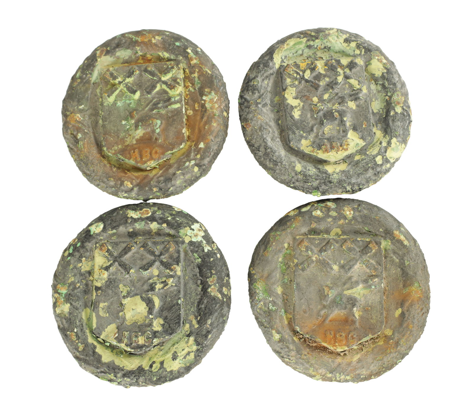 A SET OF FOUR 19TH CENTURY CAST IRON PLAQUES: A SET OF FOUR 19TH CENTURY CAST IRON PLAQUES each of circular form cast with a shield-shaped device enclosing a stag beneath a chequered band, the lower edge stamped HBC, with remnants of original pat