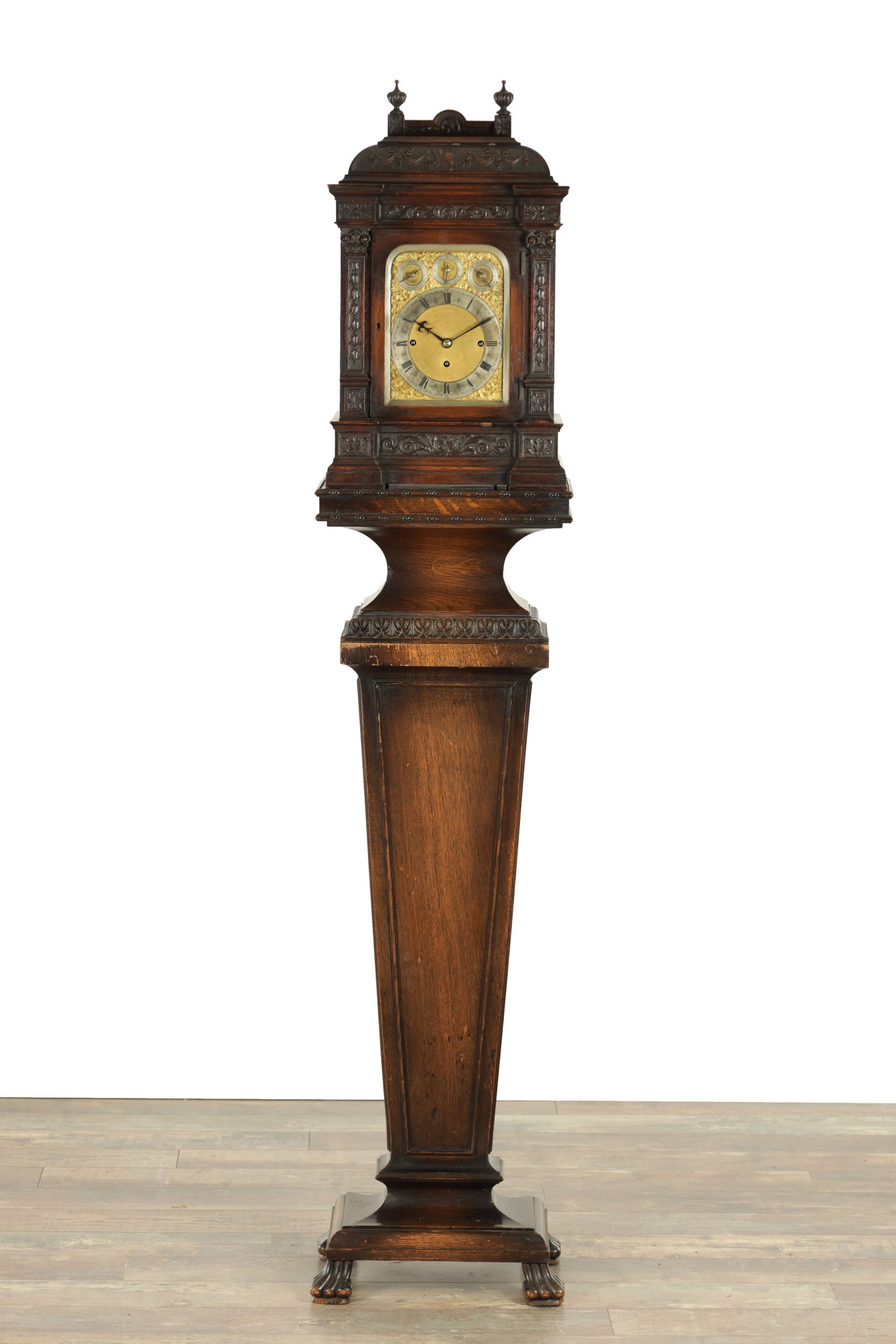 A LATE 19TH CENTURY OAK CASED TRIPLE FUSEE QUARTER CHIMING BRACKET CLOCK ON STAND: A LATE 19TH CENTURY OAK CASED TRIPLE FUSEE QUARTER CHIMING BRACKET CLOCK ON STAND the carved case with columns and pierced sound frets enclosing a 7" brass dial with gilt spandrels and silvered chapte