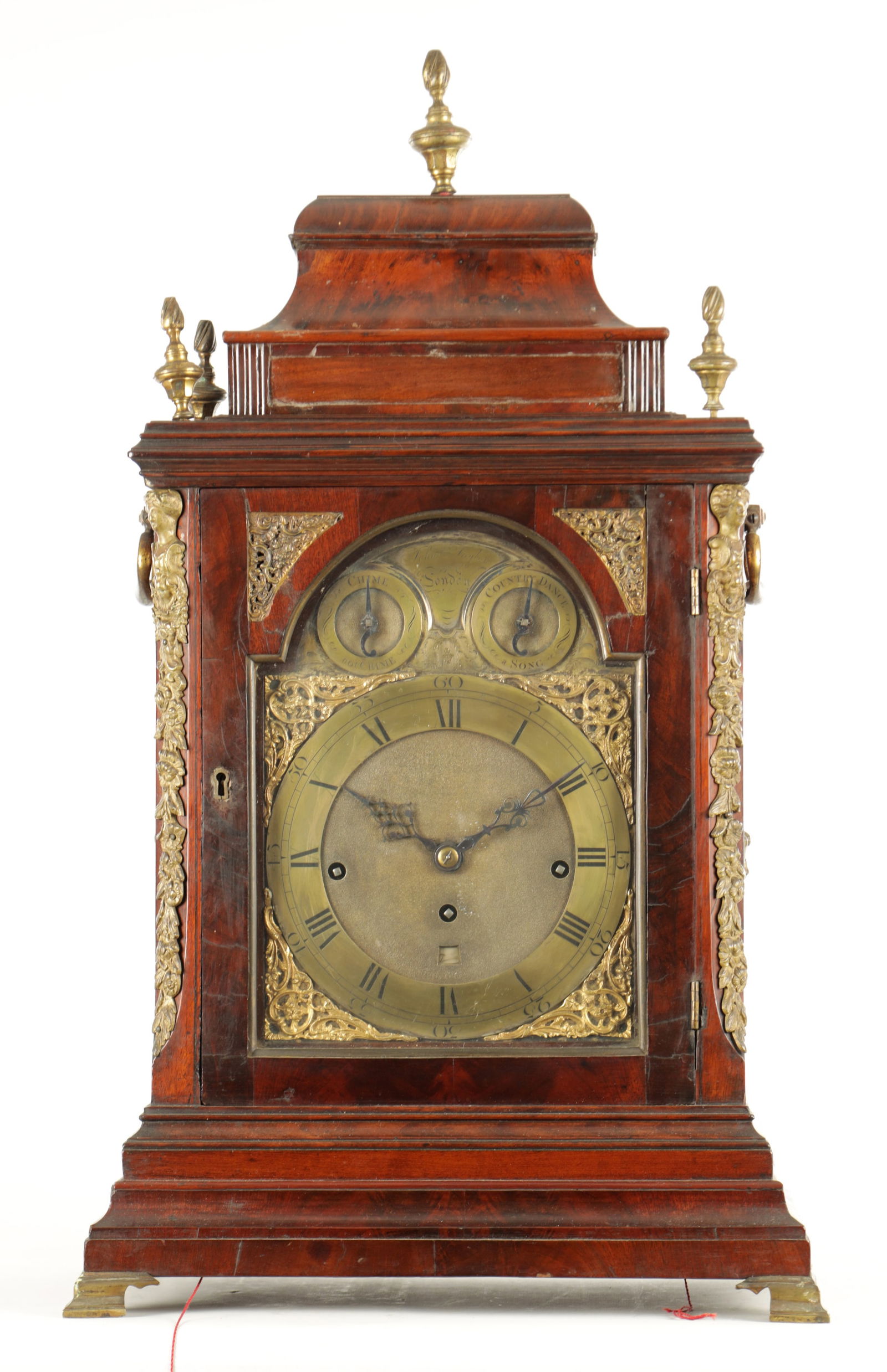 JOHN TAYLOR, LONDON. A FINE GEORGE III ORMOLU MOUNTED MAHOGANY MUSICAL BRACKET CLOCK: JOHN TAYLOR, LONDON. A FINE GEORGE III ORMOLU MOUNTED MAHOGANY MUSICAL BRACKET CLOCK the case having an inverted bell top pediment and gilt torch finials above a glazed door flanked by ormolu caryatid