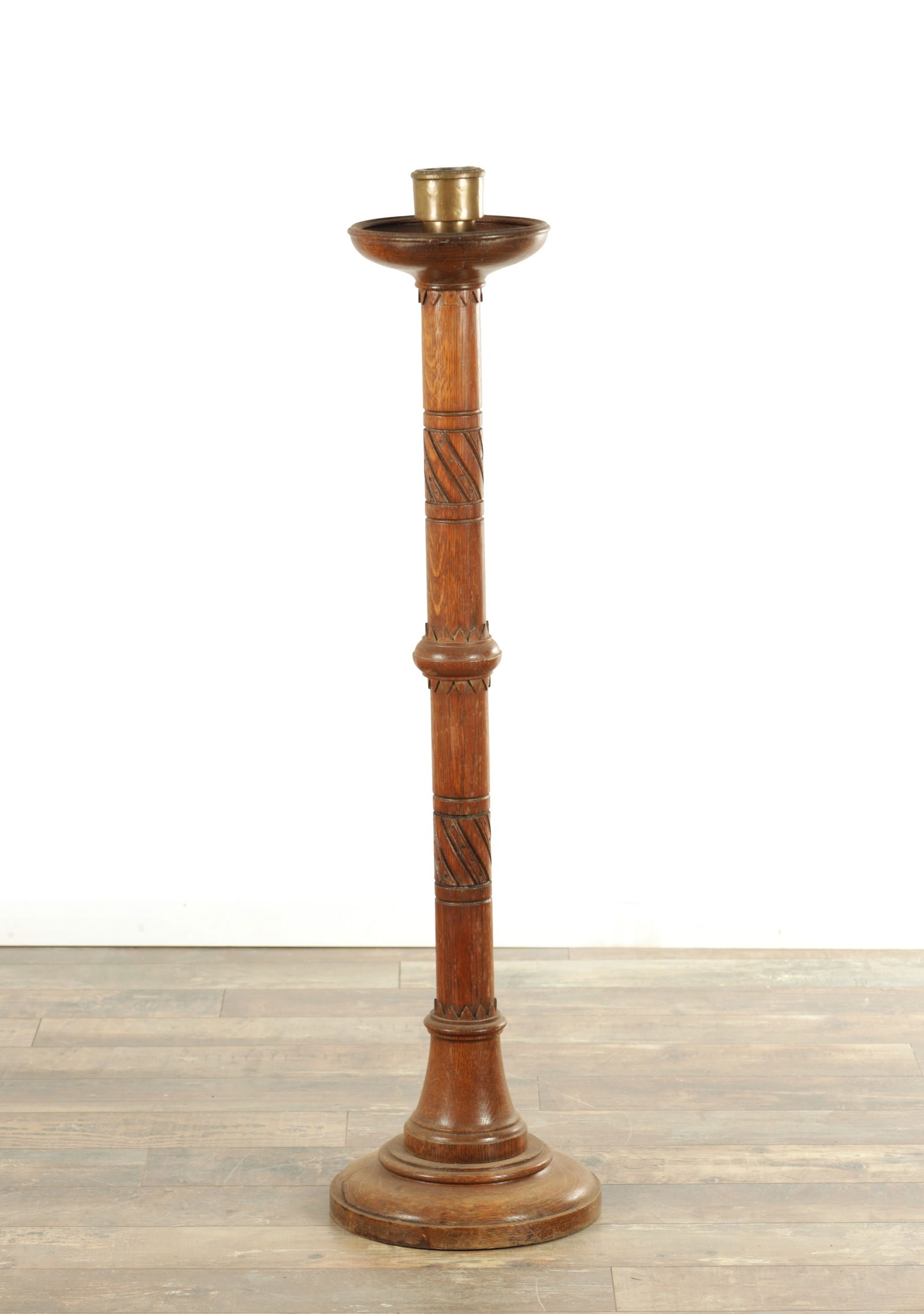 A LATE 19TH CENTURY OAK ASTHETIC PERIOD CANDLESTICK: A LATE 19TH CENTURY OAK ASTHETIC PERIOD CANDLESTICK with turned stem and circular stepped base and drip pan. (112cm high )