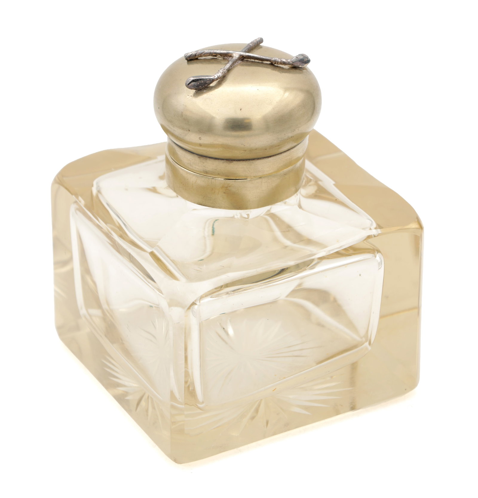 A VICTORIAN CUT GLASS INKWELL WITH DOMED METAL COVER APPLIED WITH CROSSED GOLF CLUBS: A VICTORIAN CUT GLASS INKWELL WITH DOMED METAL COVER APPLIED WITH CROSSED GOLF CLUBS of square faceted form with rounded shoulders and star-cut panels, the domed metal cover applied with crossed golf