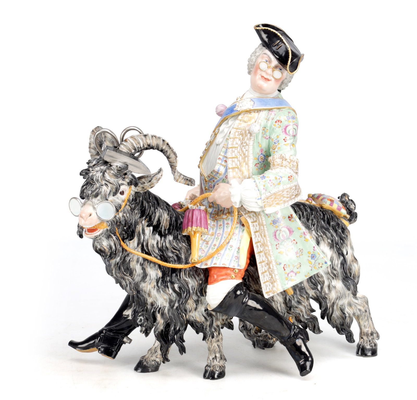 A 19TH CENTURY MEISSEN PORCELAIN GROUP OF COUNT BRUHL'S TAILOR: A 19TH CENTURY MEISSEN PORCELAIN GROUP OF COUNT BRUHL'S TAILOR modelled with the tailor in tricorn hat riding a goat wearing spectacles and boots, richly decorated in polychrome enamels with gilt high