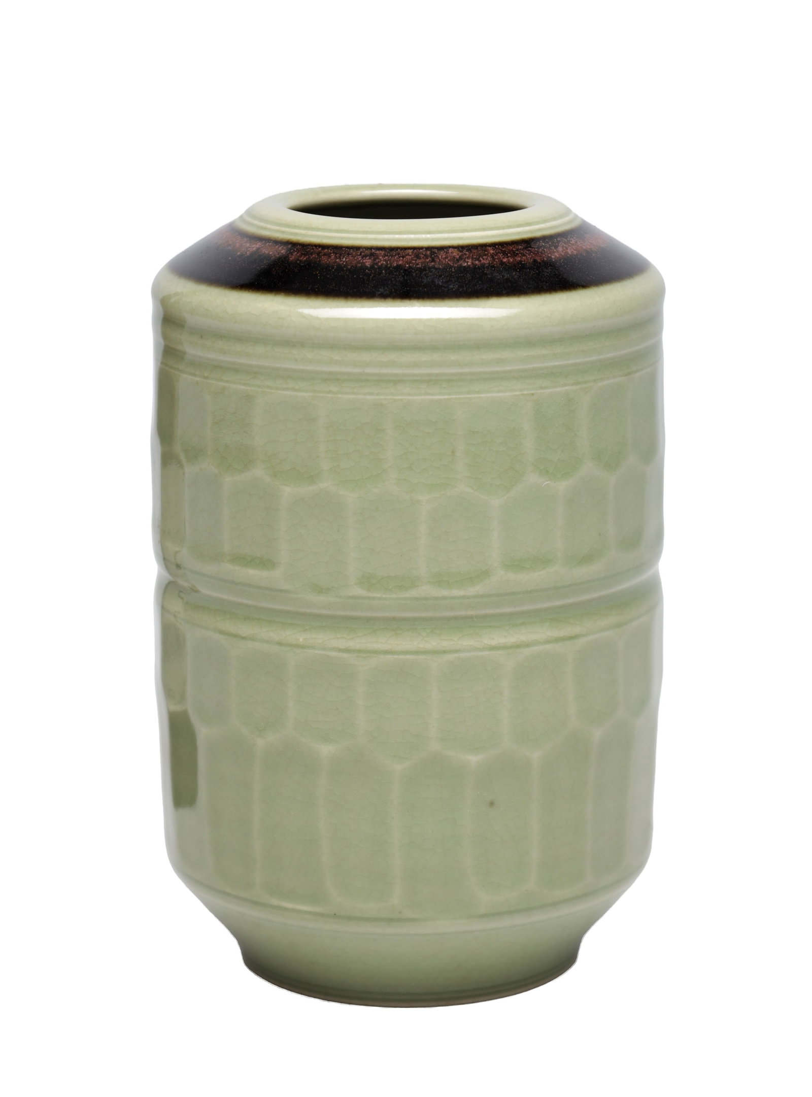 TOM TURNER A STUDIO POTTERY VASE IN A CELADON CRACKLE GLAZE: TOM TURNER A STUDIO POTTERY VASE IN A CELADON CRACKLE GLAZE of cylindrical barrel form with moulded honeycomb panels and a raised mid-band, the neck with a dark tenmoku collar and small circular mouth