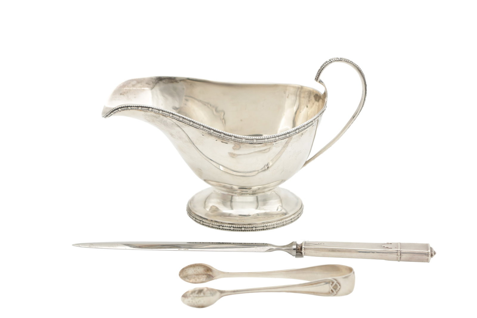 A COLLECTION OF 20TH CENTURY SILVER ITEMS: A COLLECTION OF 20TH CENTURY SILVER ITEMS comprising a silver cased letter knife, hallmarked H.Hunt, Sheffield, 1973. A pair of silver tongs, hallmarked Cooper Brothers & Sons Ltd, Sheffield, 1924. A