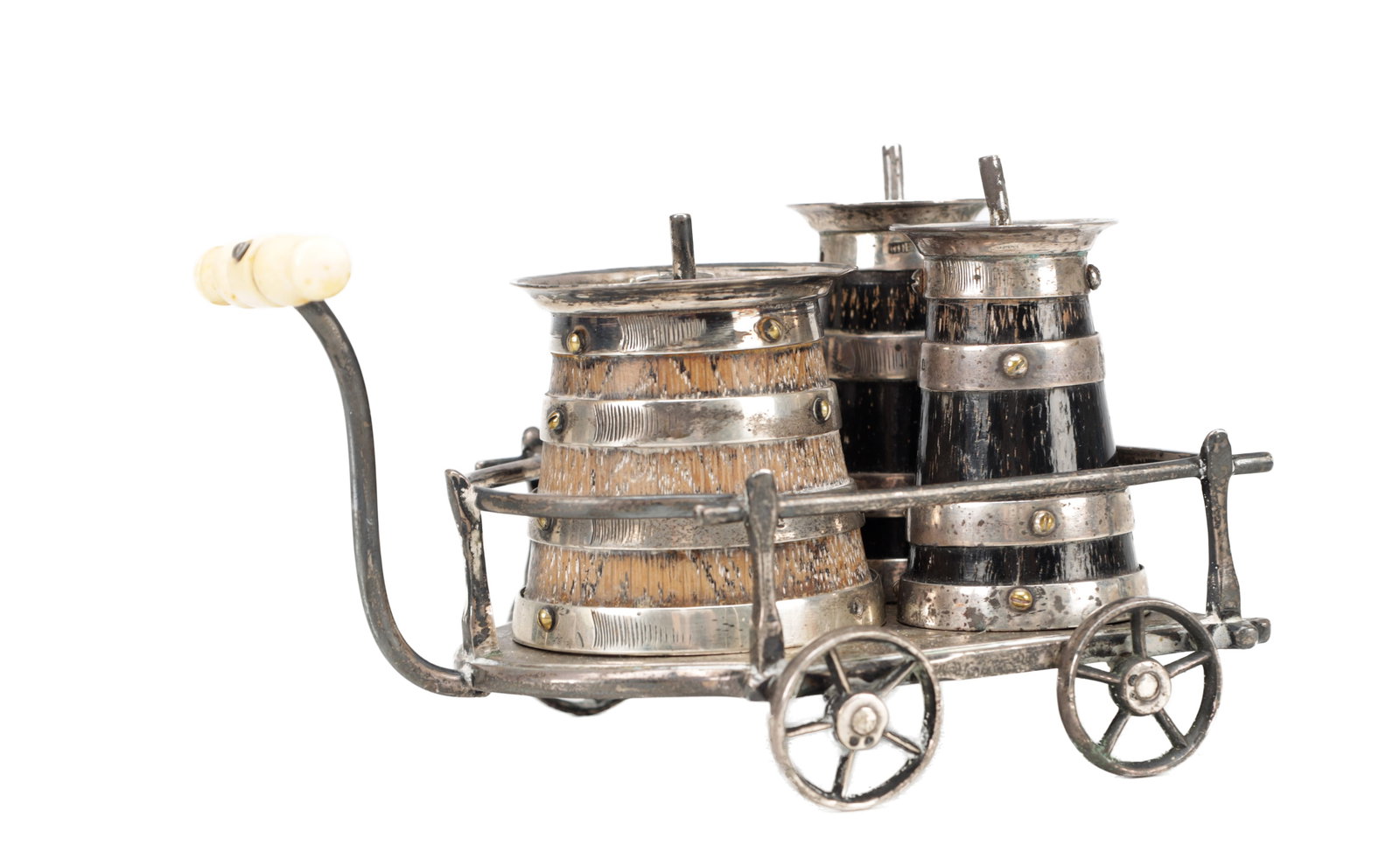 A VICTORIAN NOVELTY OAK AND SILVER MOUNTED CONDIMENTS SET: A VICTORIAN NOVELTY OAK AND SILVER MOUNTED CONDIMENTS SET modelled as coopered barrel pots within a wheeled cart with spoked wheels and a pull handle with ivorine grip, the barrels with silver banding