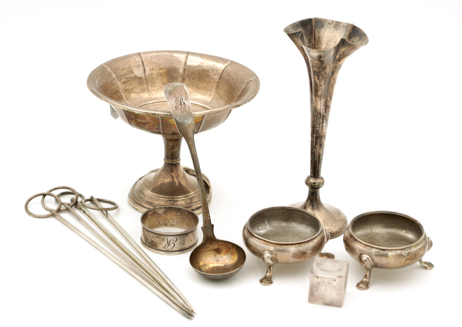 A COLLECTION OF SILVER ITEMS: A COLLECTION OF SILVER ITEMS comprising a spill vase, a small Scottish ladle, a snooker chalk holder, a pair of table salts, a napkin ring, a tazza with a loaded base, and four silver meat picks. Tota