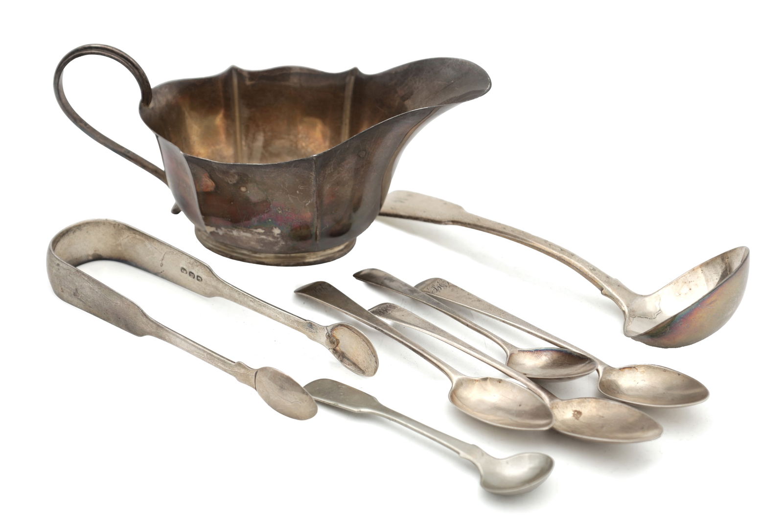 A COLLECTION OF GEORGIAN SILVER TABLEWARE: A COLLECTION OF GEORGIAN SILVER TABLEWARE comprising four teaspoons, a salt spoon, a sauce spoon, a pair of sugar tongs and a cream jug, each hallmarked, total weight app. 310g (8). (Length 18cm and s