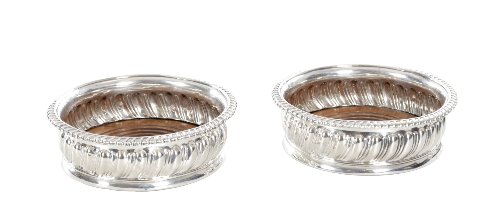 A PAIR OF EARLY 19TH CENTURY ENGLISH SILVER WINE COASTERS: A PAIR OF EARLY 19TH CENTURY ENGLISH SILVER WINE COASTERS with gadrooned sides and rope twist borders, each with turned wooden bases and green felt undersides. Hallmarked London 1814, maker John Rober