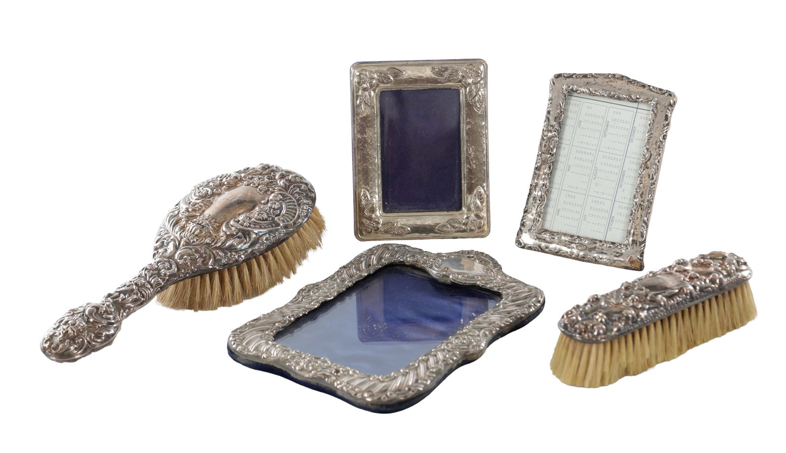 A COLLECTION OF 20TH CENTURY SILVER ITEMS: A COLLECTION OF 20TH CENTURY SILVER ITEMS comprising a silver hair brush, a silver hairbrush, and three silver picture frames. All hallmarked sterling silver.