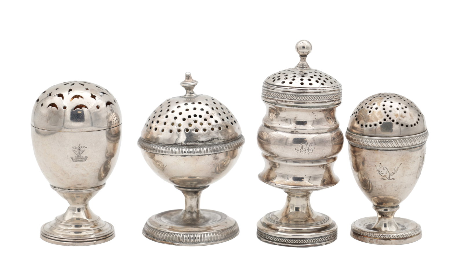 A COLLECTION OF FOUR GEORGIAN ENGLISH SILVER PEPPER CASTERS: A COLLECTION OF FOUR GEORGIAN ENGLISH SILVER PEPPER CASTERS of varying design with pierced domed covers and circular pedestal bases, several engraved with crests, hallmarked London 1812, 1819, 1808 an