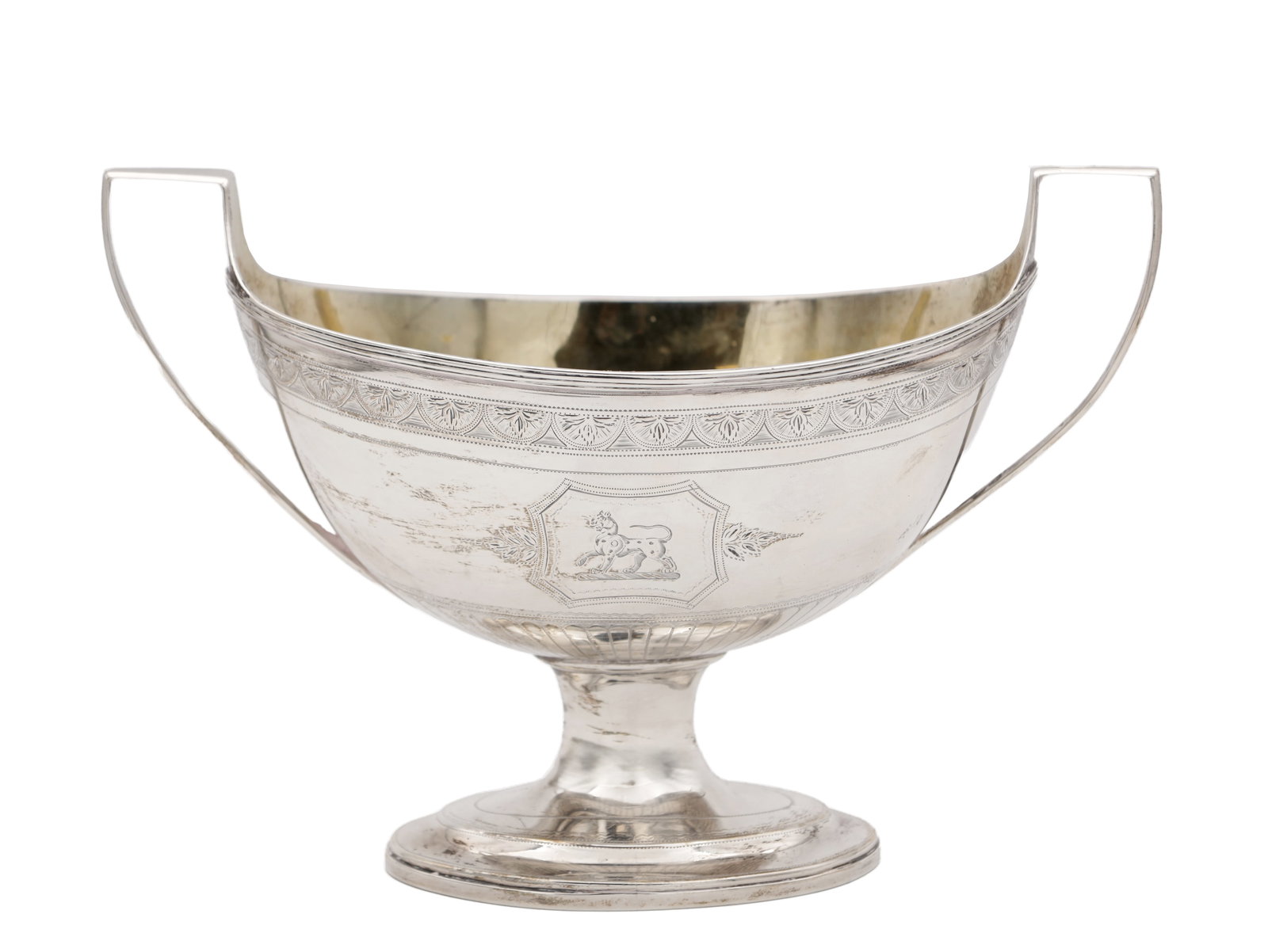 A GEORGE III SILVER SUGAR BASKET: A GEORGE III SILVER SUGAR BASKET with arcaded border, armorial panels and reeded decoration; raised on an oval foot with shaped side handles. Hallmarked London 1795 by Robert Jones. Total weight app.