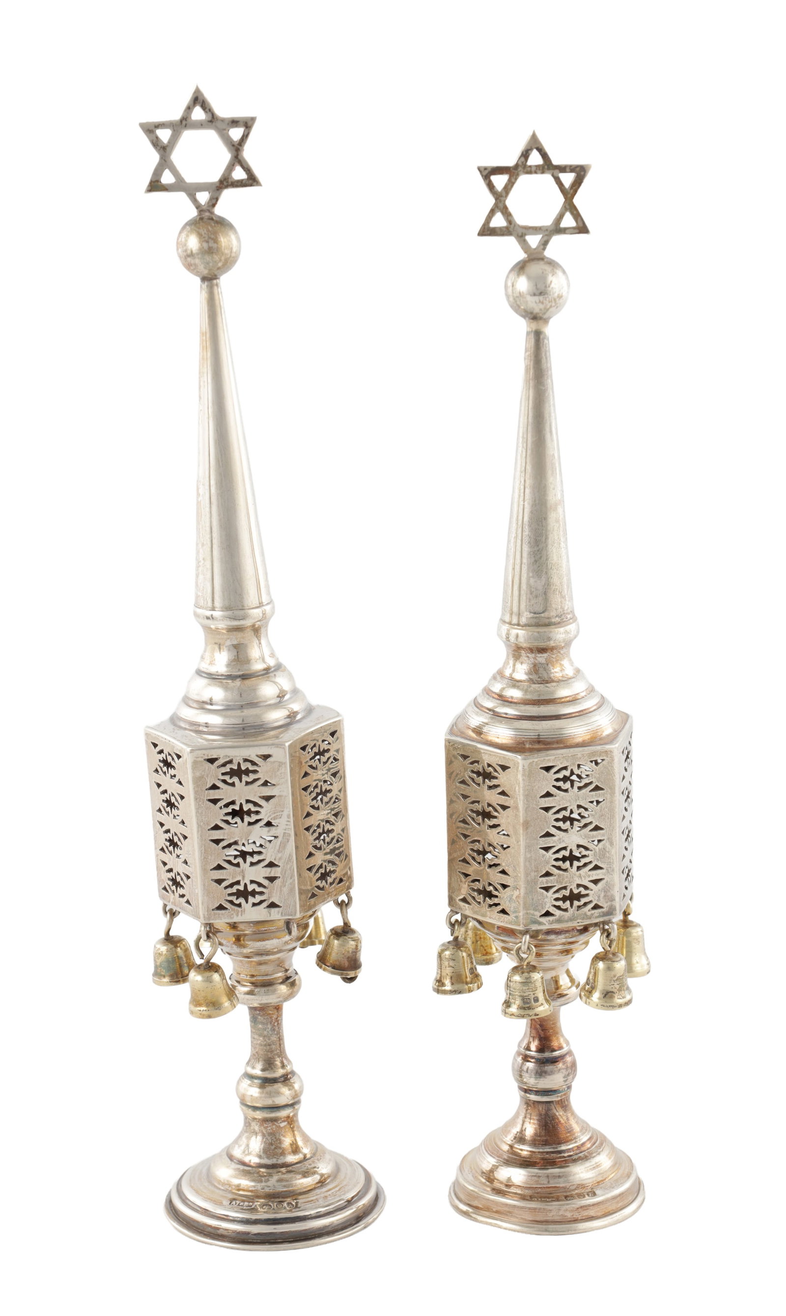 TWO MID 20TH CENTURY JEWISH SILVER SPICE TOWERS: TWO MID 20TH CENTURY JEWISH SILVER SPICE TOWERS both surmounted by a ball and the star of David on a tapering turret, with an octagonal pierced body with a hinged door and suspended bells on a turned