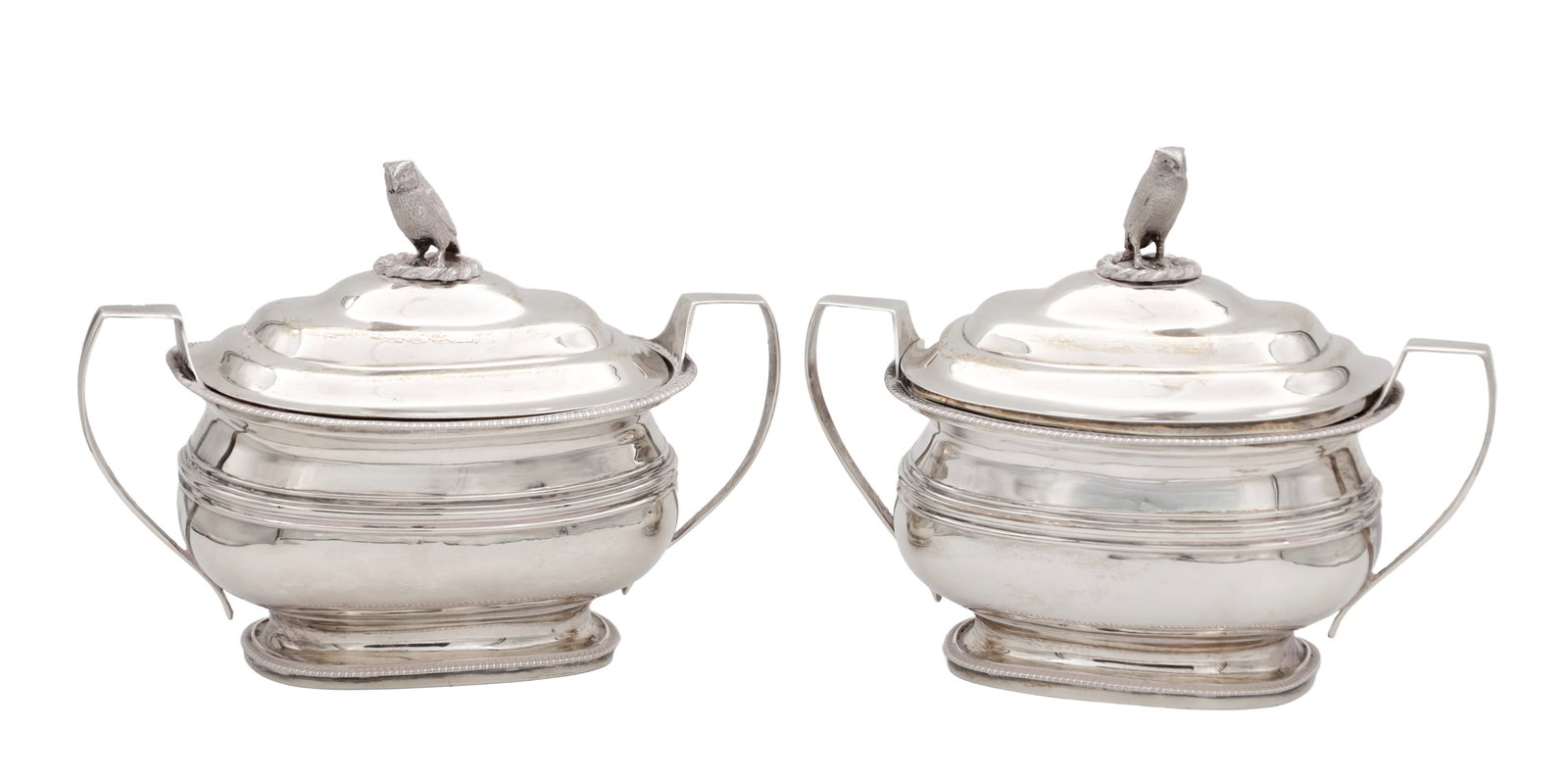 A PAIR OF GEORGE III SAUCE TUREENS: A PAIR OF GEORGE III SAUCE TUREENS of oblong form with domed lids surmounted by owl finials, the bodies with engraved crest 16cm high, 21cm wide. Hallmarked R & S Hennell, London 1805. Total weight ap