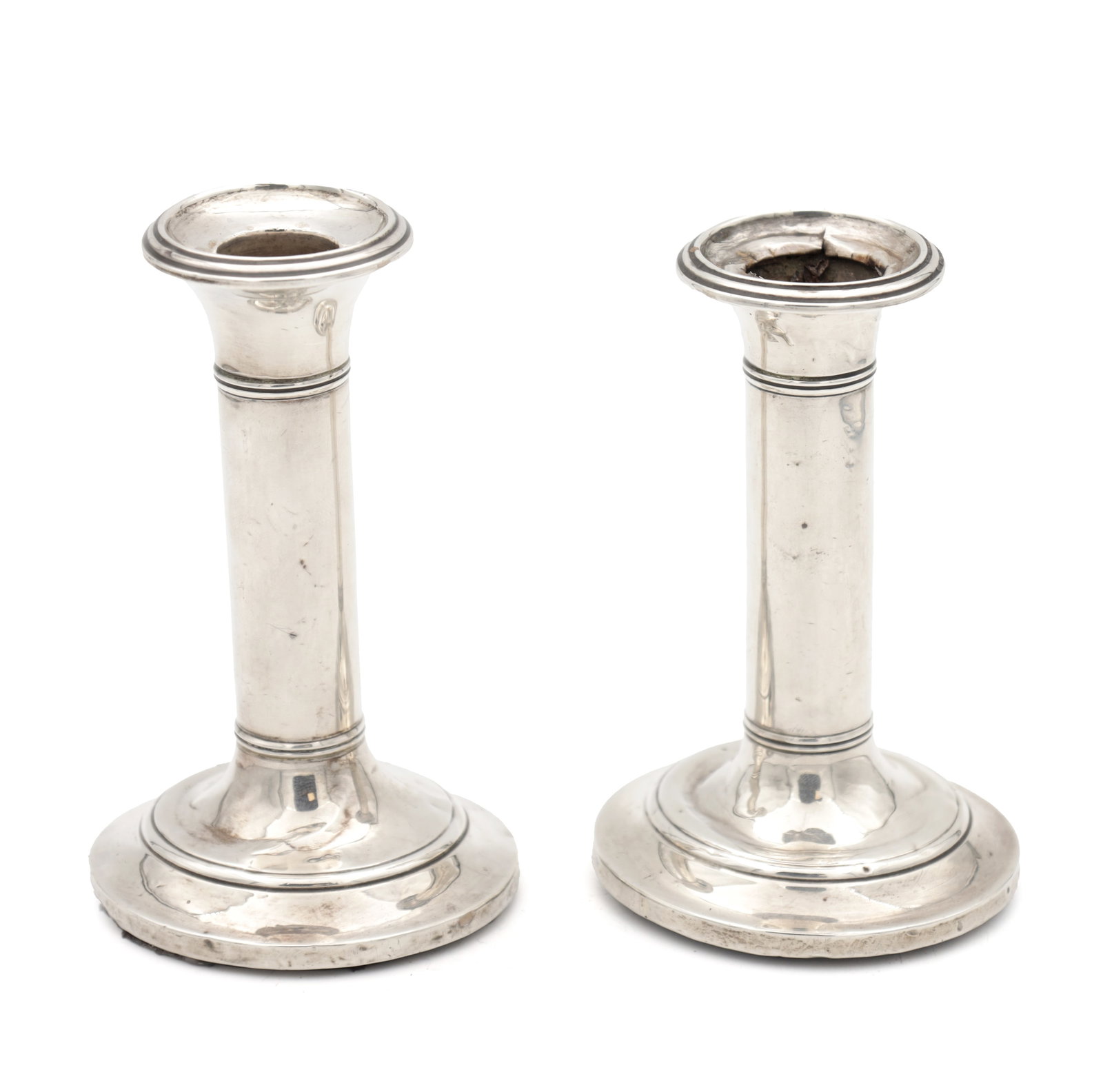 A PAIR OF EDWARDIAN ENGLISH SILVER CANDLESTICKS: A PAIR OF EDWARDIAN ENGLISH SILVER CANDLESTICKS hallmarked Birmingham 1906 by S Blanckensee & Son Ltd with filled bases; total weight including wooden bases app. 450g. (Height 12.5cm)