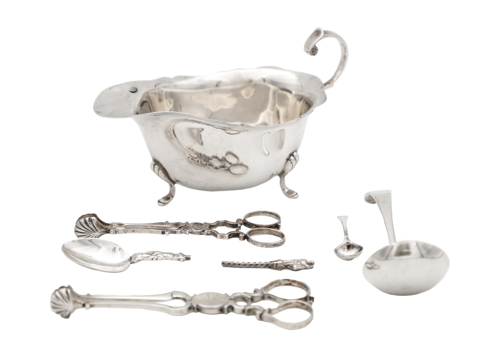 A COLLECTION OF LATE 19TH/EARLY 20TH CENTURY ENGLISH SILVER TABLEWARE: A COLLECTION OF LATE 19TH/EARLY 20TH CENTURY ENGLISH SILVER TABLEWARE comprising a sauce boat with wavy rim and scroll handle on three hoof feet, a sauce ladle, a teaspoon, a small salt spoon and two