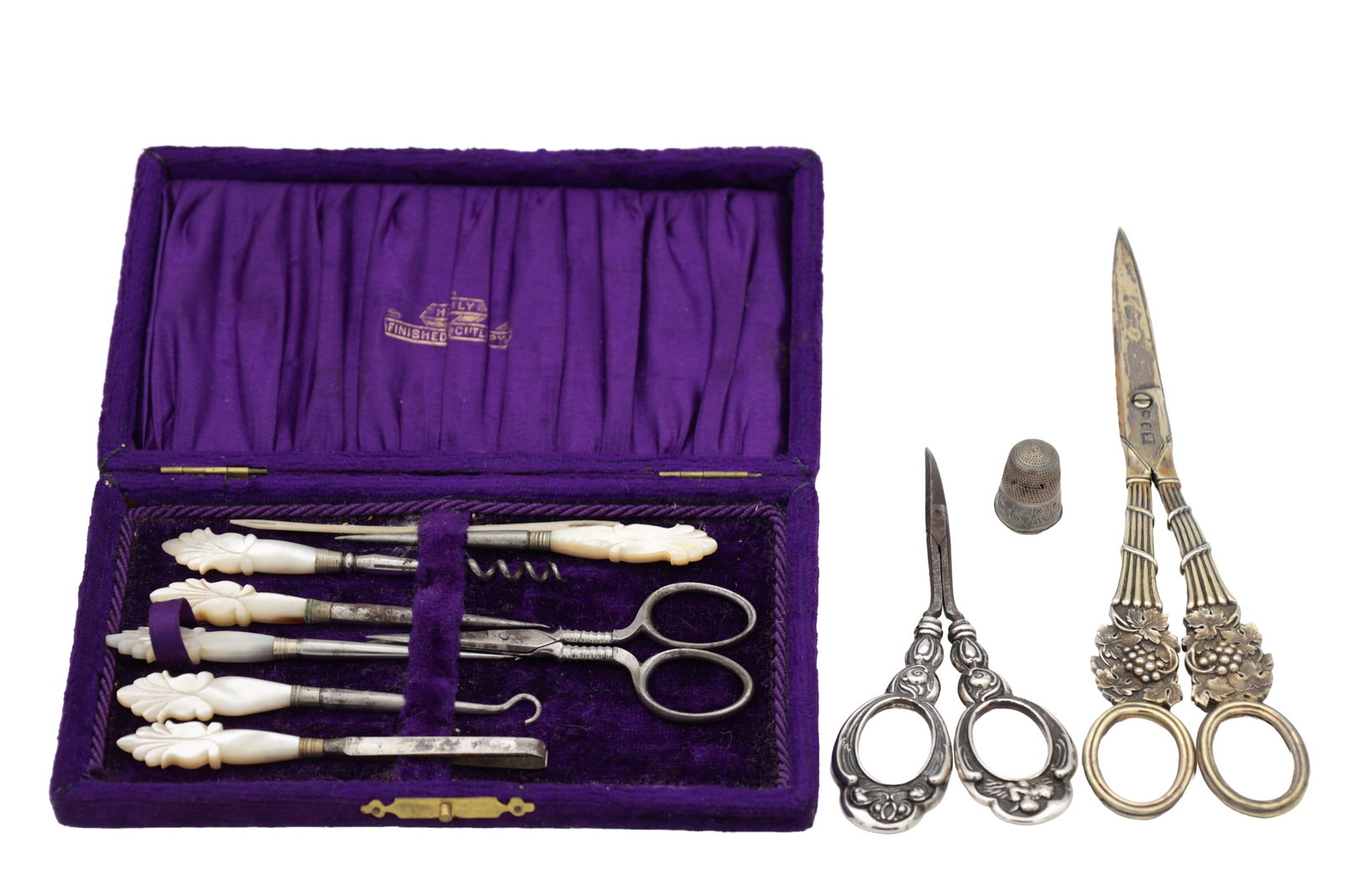 A PAIR OF GEORGIAN SILVER GILT GRAPE SCISSORS AND OTHER ITEMS: A PAIR OF GEORGIAN SILVER GILT GRAPE SCISSORS AND OTHER ITEMS comprising silver handled mail scissors, a silver thimble and a cased manicure set.