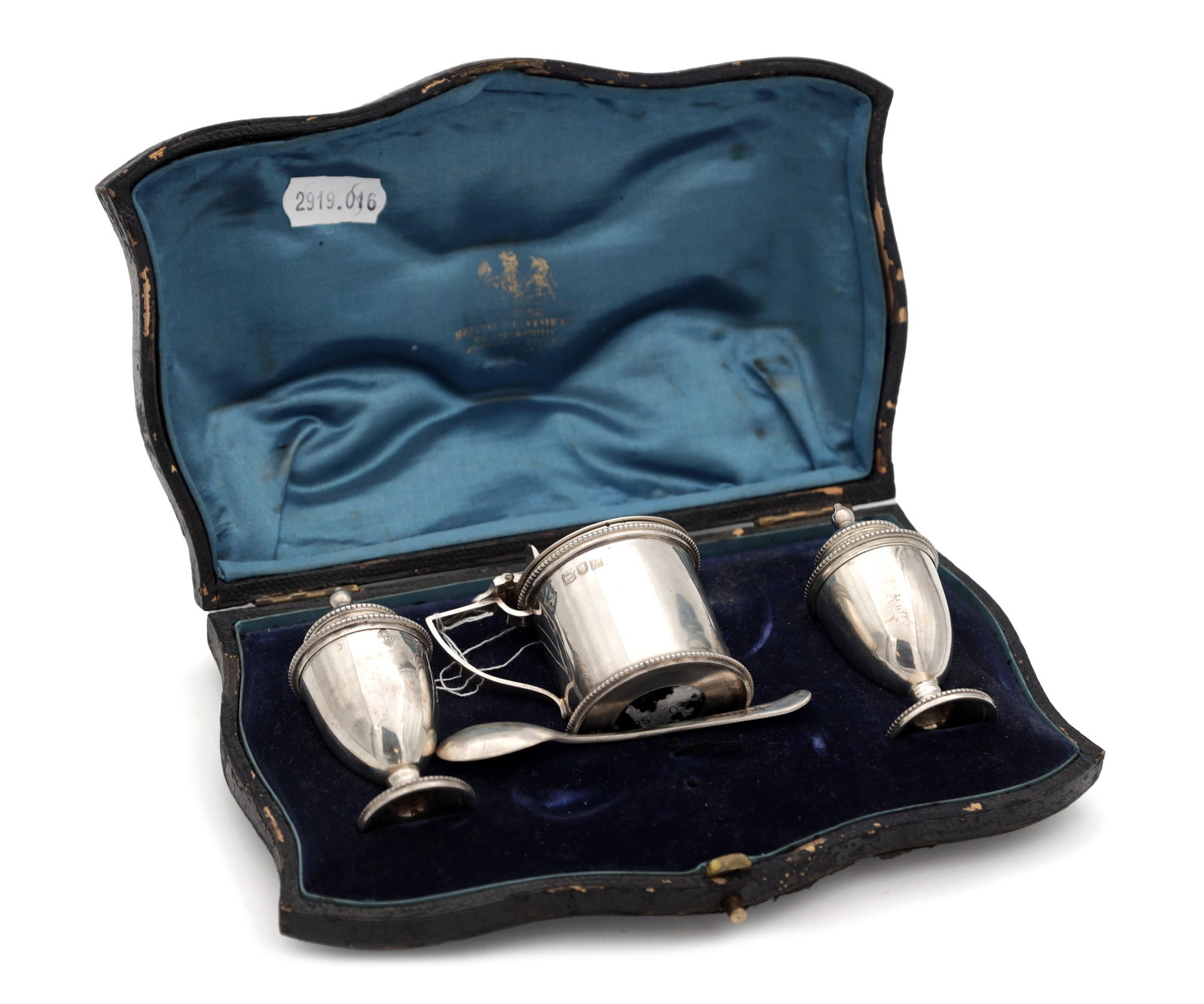 A LATE 19TH CENTURY ENGLISH SILVER CASED THREE PIECE CRUET SET: A LATE 19TH CENTURY ENGLISH SILVER CASED THREE PIECE CRUET SET comprising two urn-shaped pepperettes and a cylindrical mustard pot with hinged cover and beaded borders with a mustard spoon in a fitted