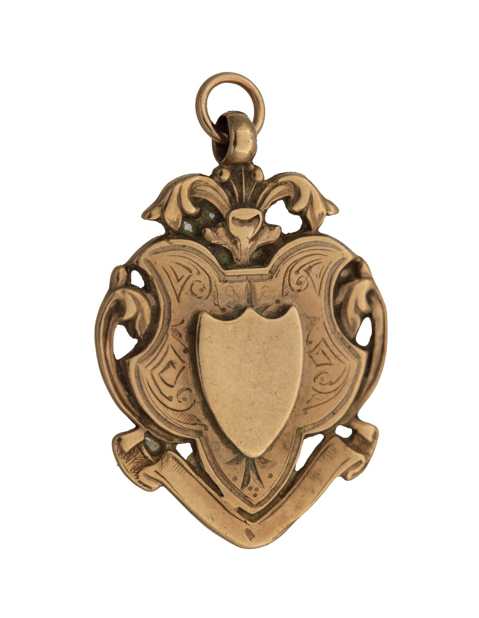 A 14CT YELLOW GOLD FOB MEDAL: A 14CT YELLOW GOLD FOB MEDAL of shield-shaped form with engraved foliate decoration and a central vacant cartouche, with pierced scrollwork and suspension loop. Total app. weight 6.7g. (33mm high,