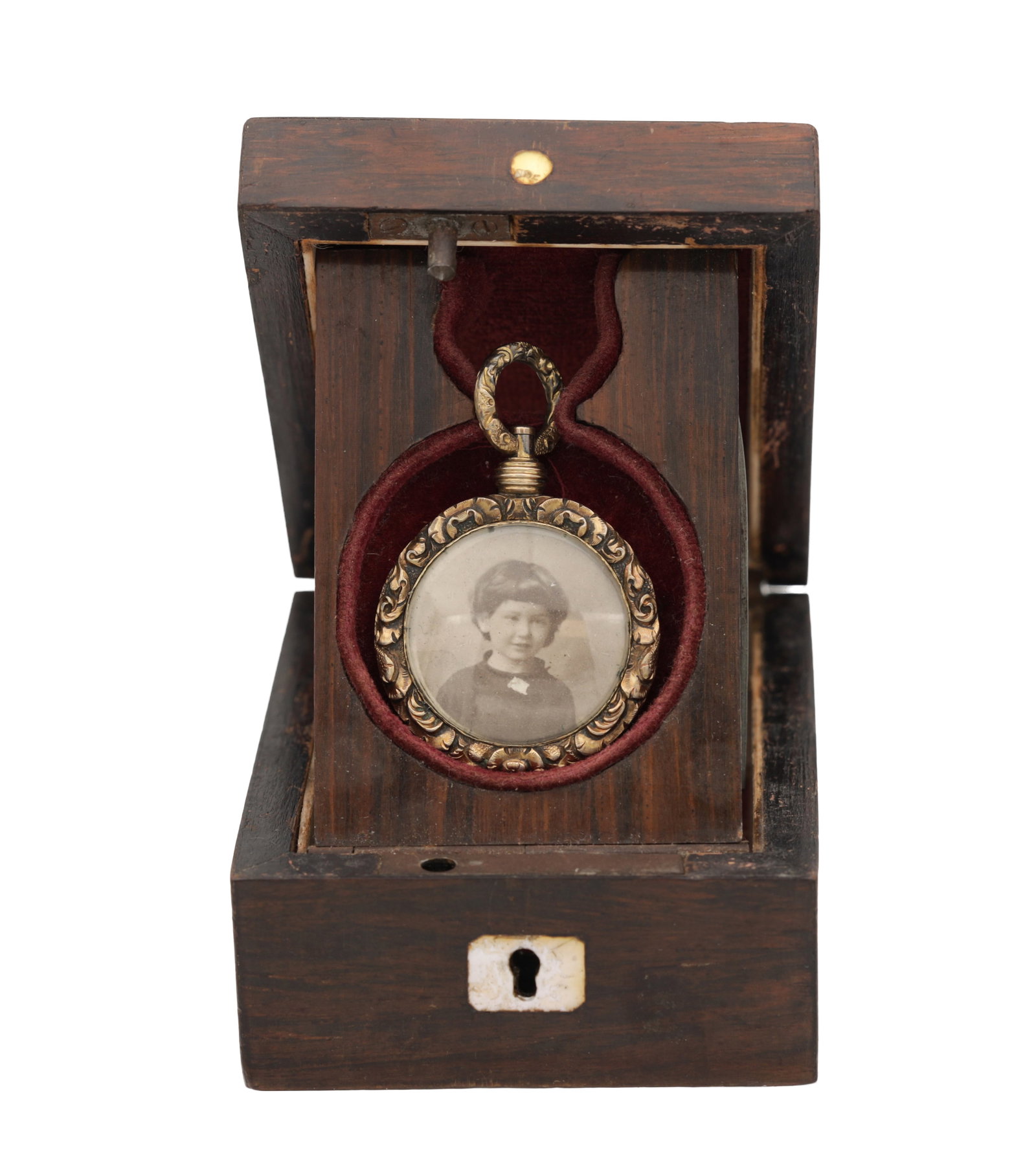 A VICTORIAN ROLLED GOLD CIRCULAR PHOTOGRAPH LOCKET PENDANT: A VICTORIAN ROLLED GOLD CIRCULAR PHOTOGRAPH LOCKET PENDANT with foliate border and twisted suspension loop enclosing a monochrome portrait photograph, in a fitted wooden case with velvet-lined interio