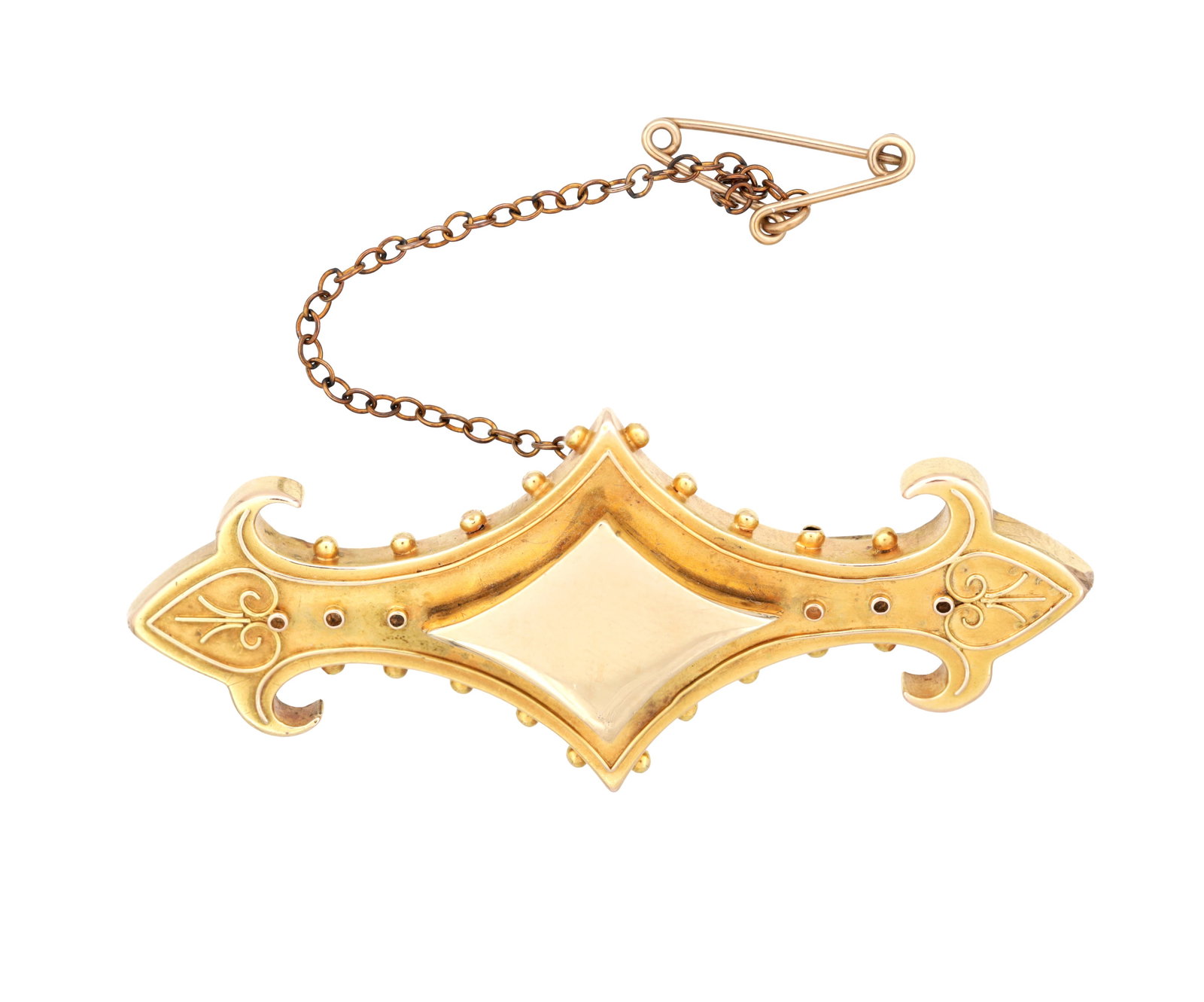 A VICTORIAN 18CT YELLOW GOLD BROOCH WITH LOCKET BACK AND SAFETY CHAIN: A VICTORIAN 18CT YELLOW GOLD BROOCH WITH LOCKET BACK AND SAFETY CHAIN of shaped outline with a lozenge-centred cartouche and applied bead and scroll ornament, the reverse with a small glass window; to
